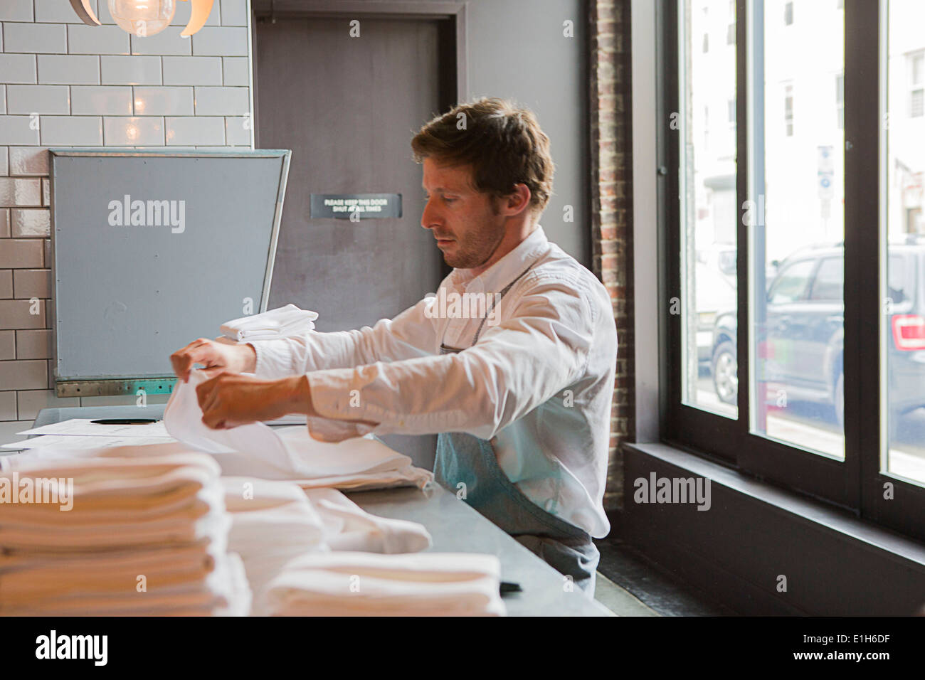 Chef preparing napkins in restaurant Stock Photo