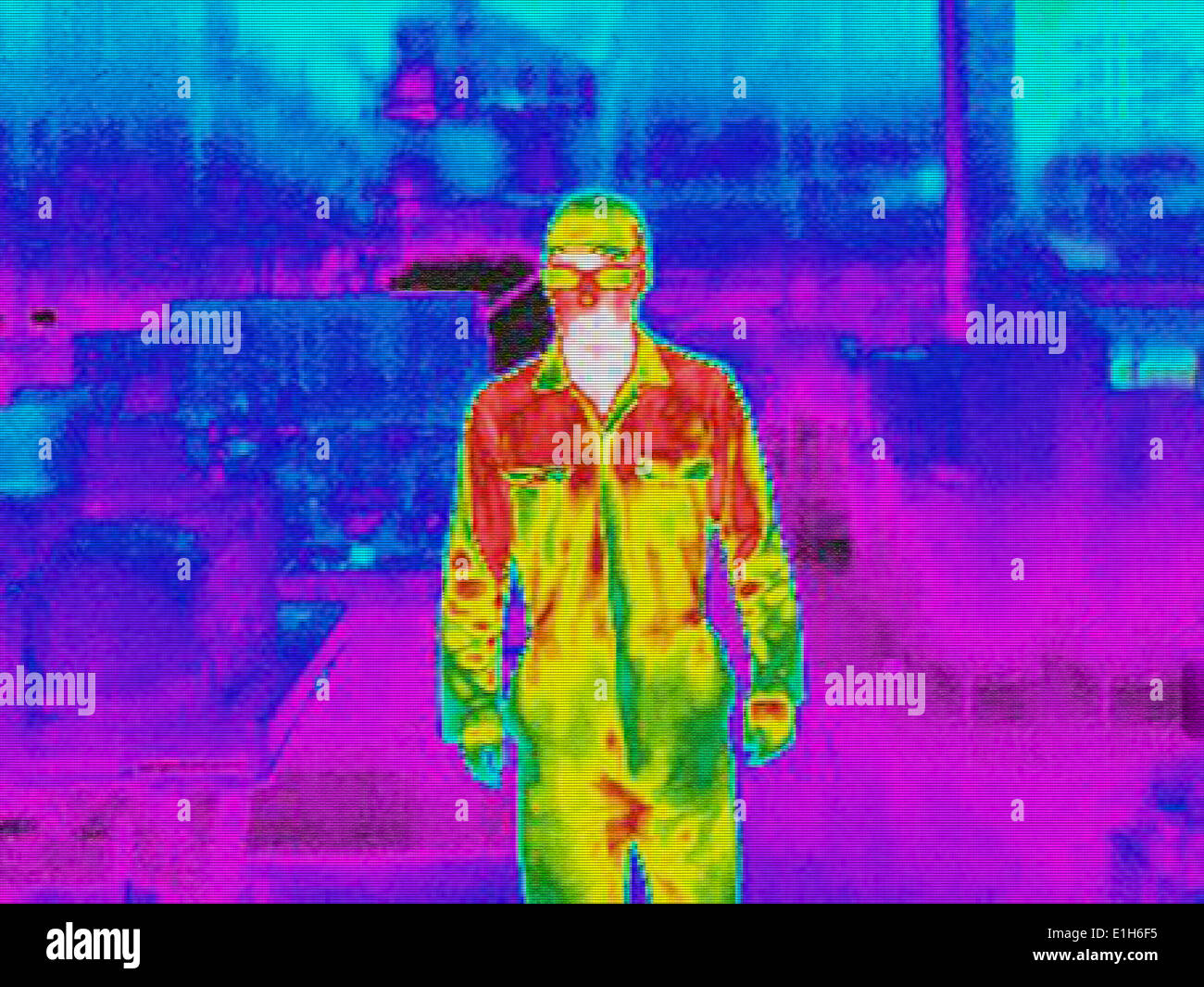 Infra red heat image of worker in factory Stock Photo