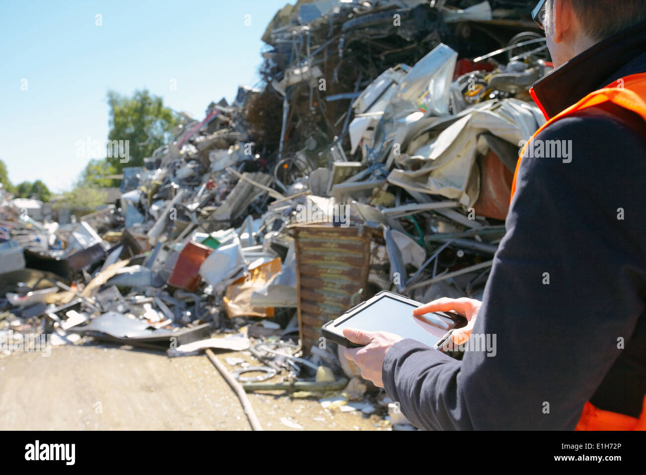 Foreman using digital tablet at scrap metal recycling plant Stock Photo