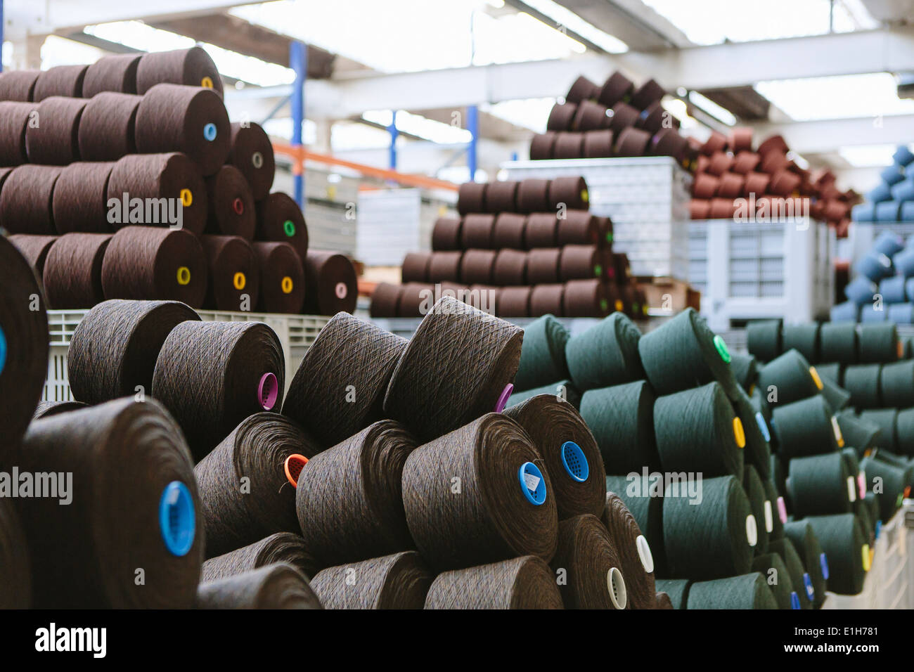 Reels of wool in storage room in woollen mill Stock Photo