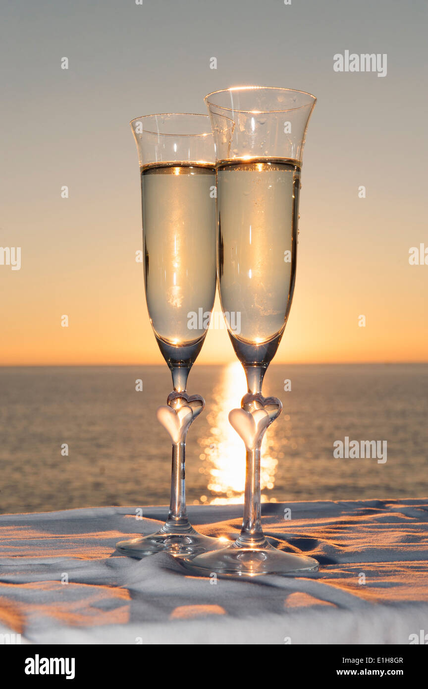 Two champagne flutes against sunset Stock Photo