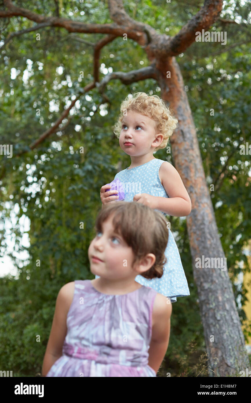 Candid portrait of two young sisters looking up Stock Photo