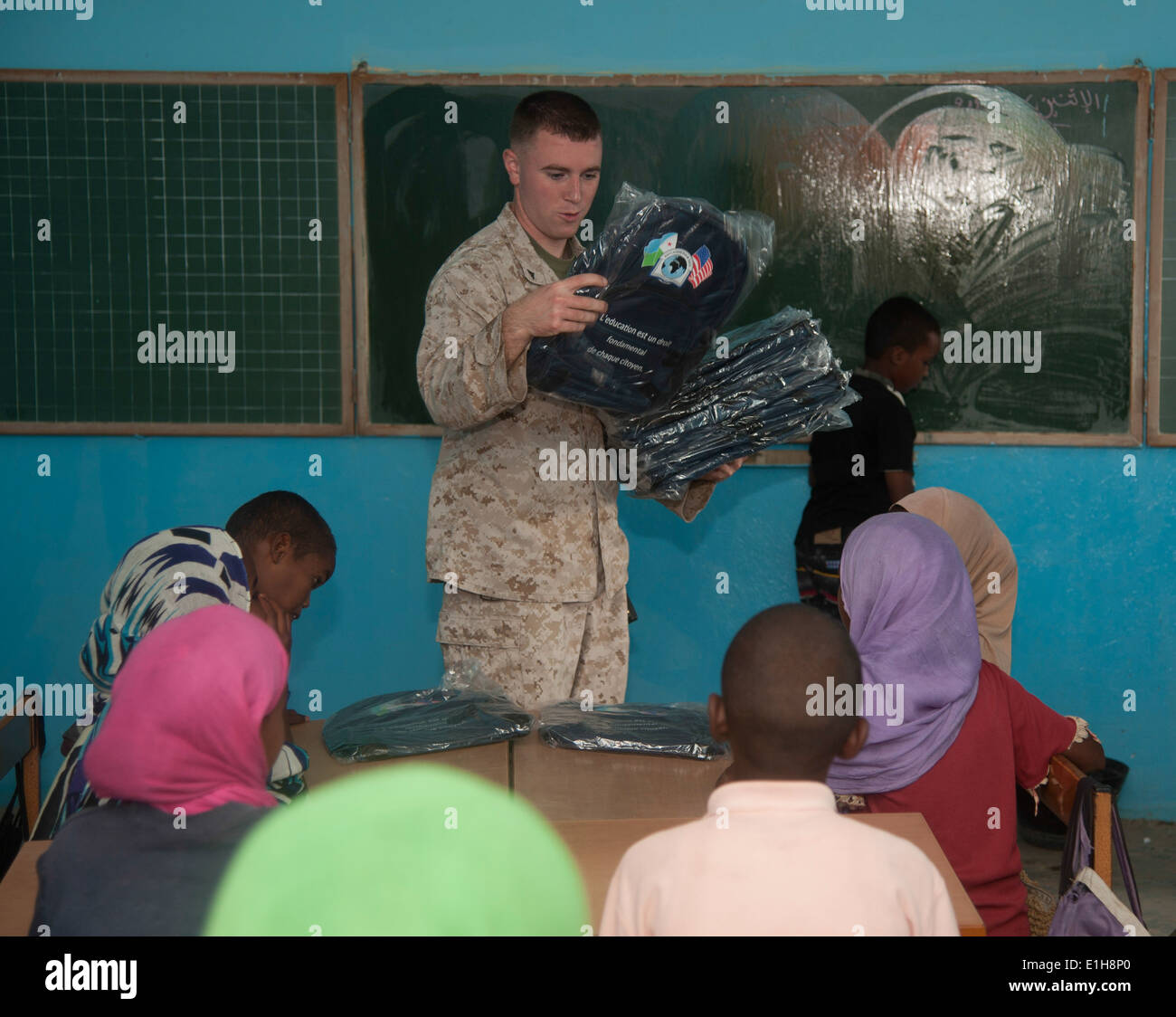 U.S. Marine Corps Lance Cpl. Kevin Howard, center, a radio transmission