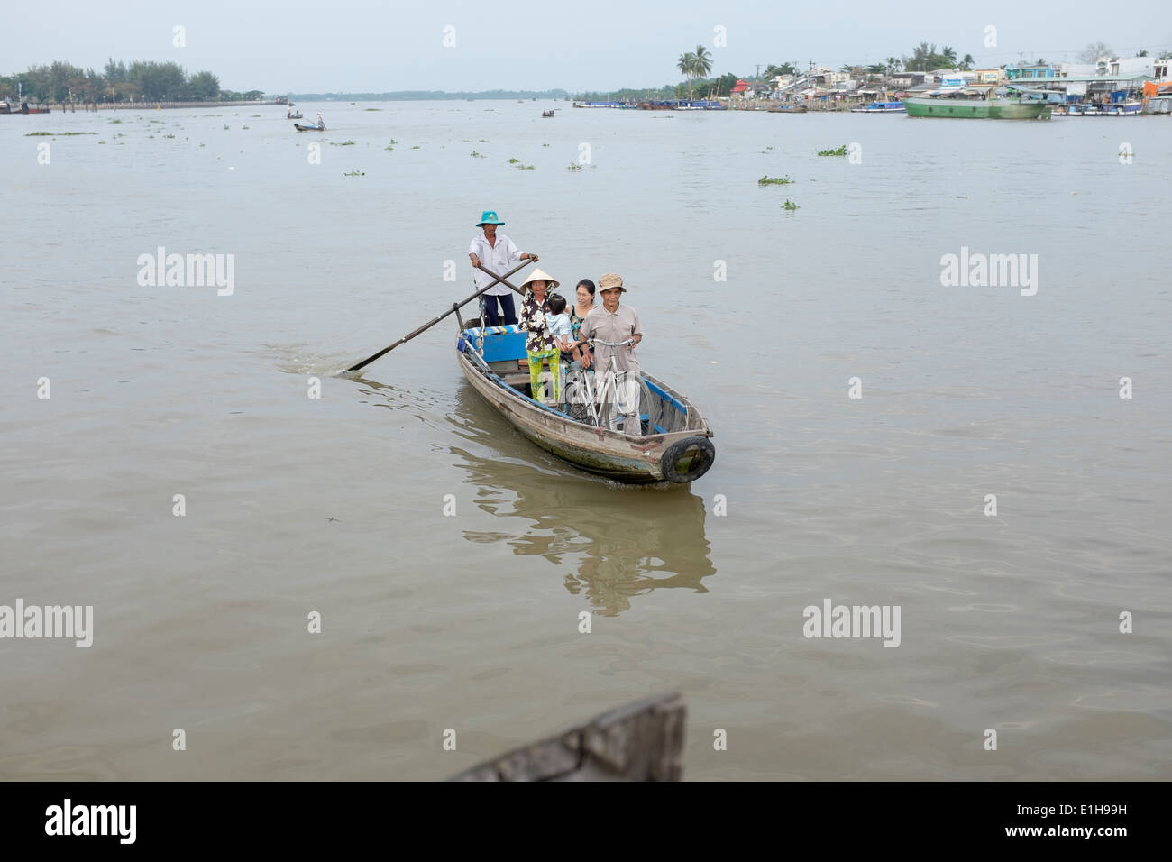 Private Boats for Hire to cross river or tour canals ands markets on waterfront at Can Tho in Vietnam Stock Photo