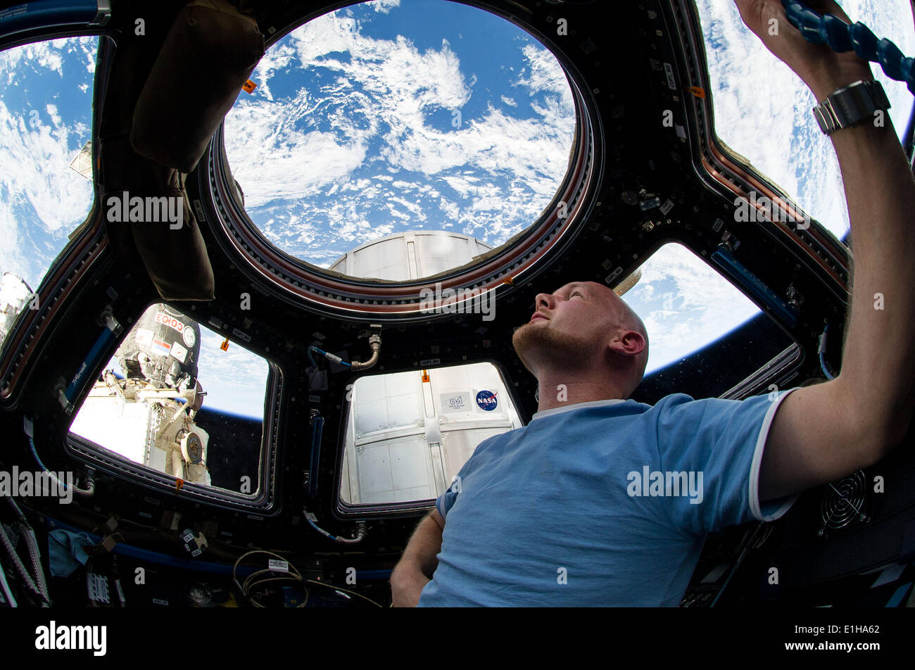 European Space Agency astronaut Alexander Gerst looks at the Earth from inside the Cupola onboard the International Space Station June 1, 2014 in Earth Orbit. Stock Photo