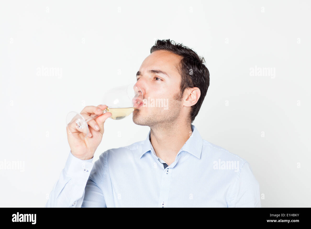 Man drinking a glass of white wine Stock Photo