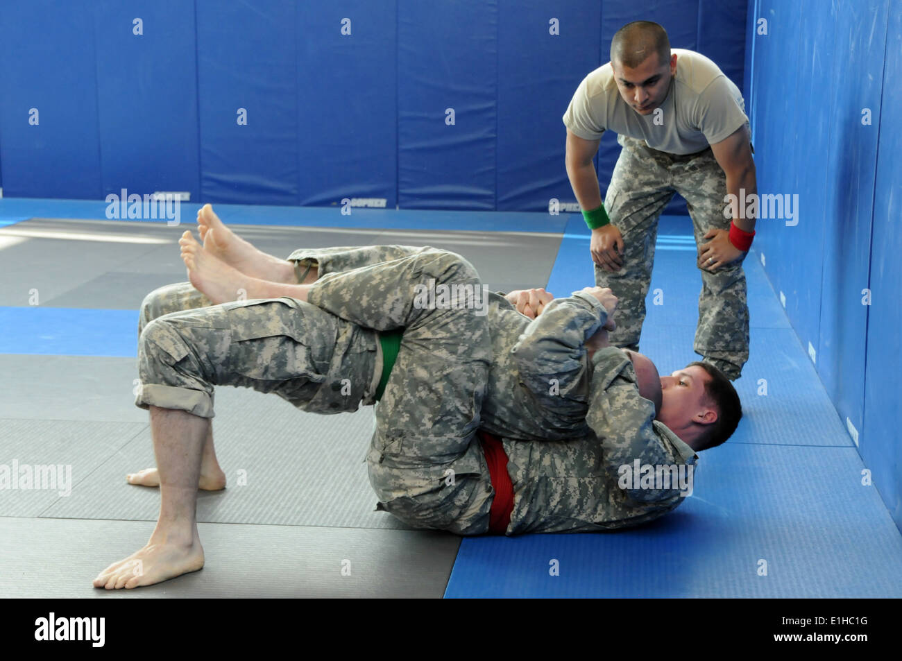U.S. Army Staff Sgt. Brian Barnard and Spc. Jonathan Ellis compete in a combatives tournament on the first day of the Installat Stock Photo
