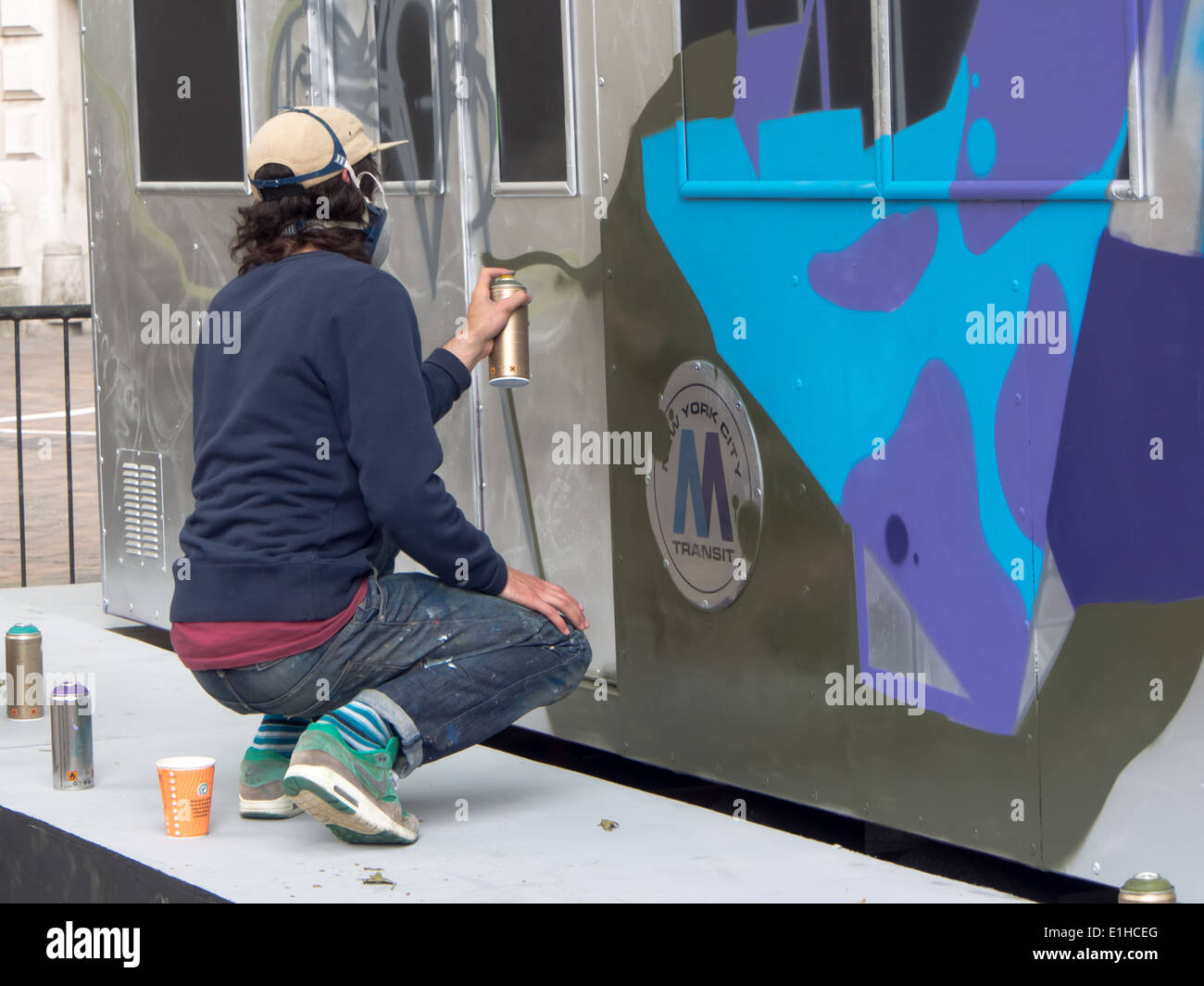 A replica New York city Subway Carriage is used as a canvas for  a street artist during the first Portsmouth Street Games. Stock Photo