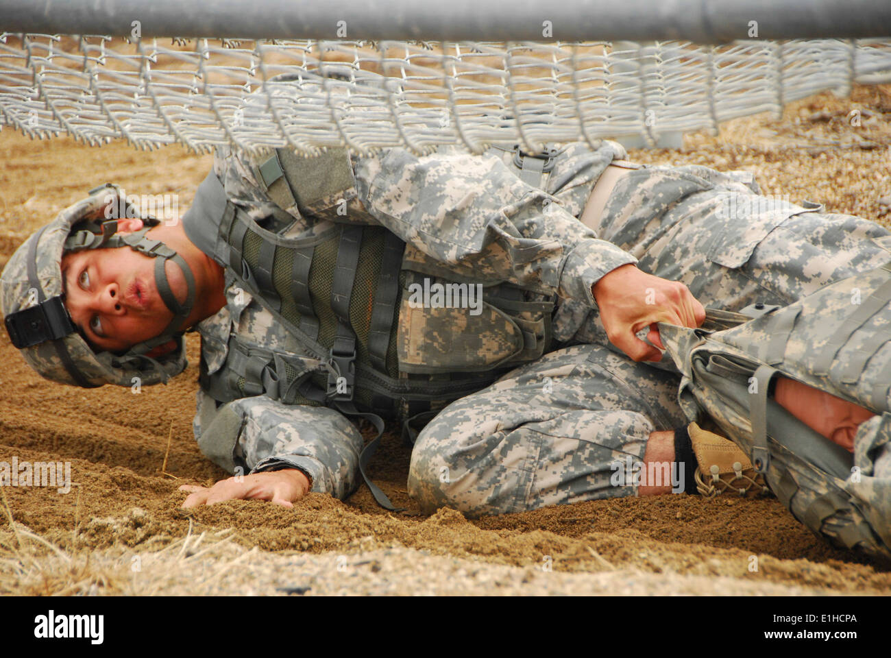 California Army National Guard Staff Sgt. Demetrius McCowan drags a casualty dummy during an obstacle course event in the 2012 Stock Photo