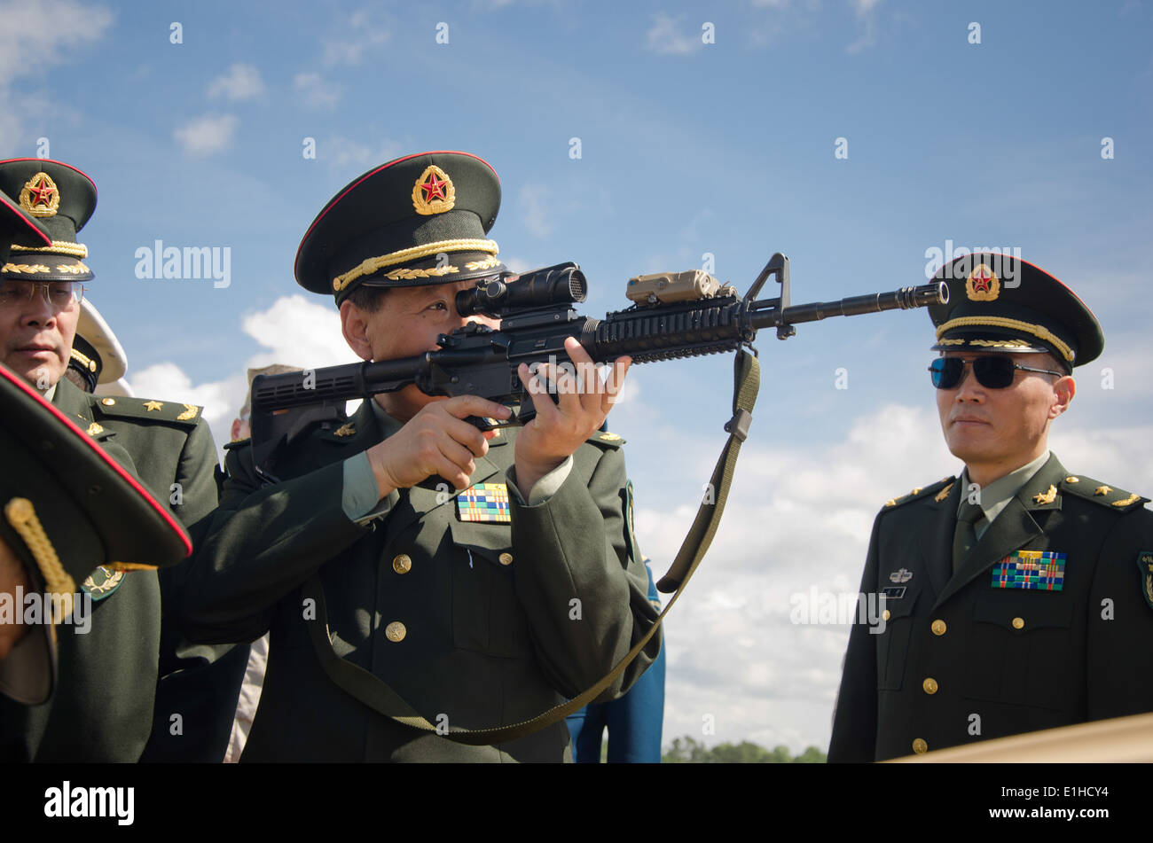 A Chinese general officer visiting Marine Corps Base Camp Lejeune, N.C., holds an M4 carbine May 9, 2012. Chinese Minister of N Stock Photo