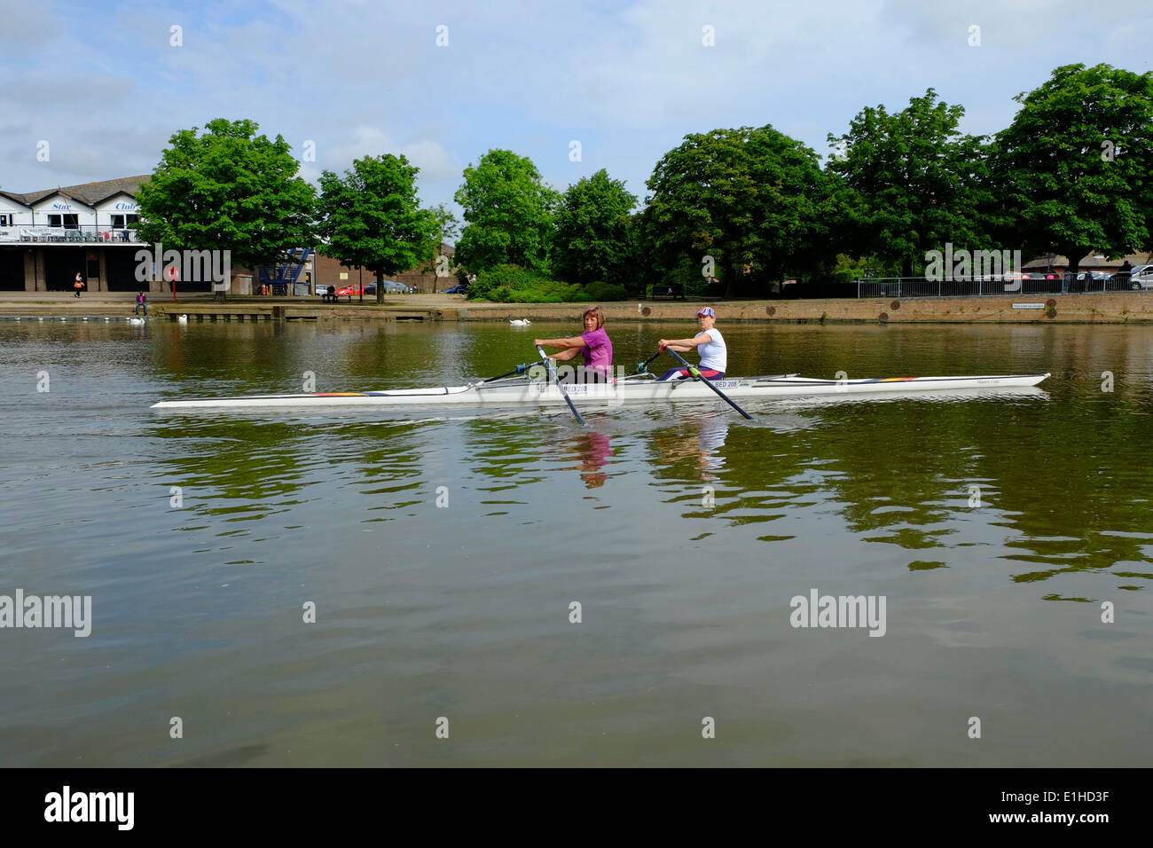 two women rowing a boat in Bedford Stock Photo