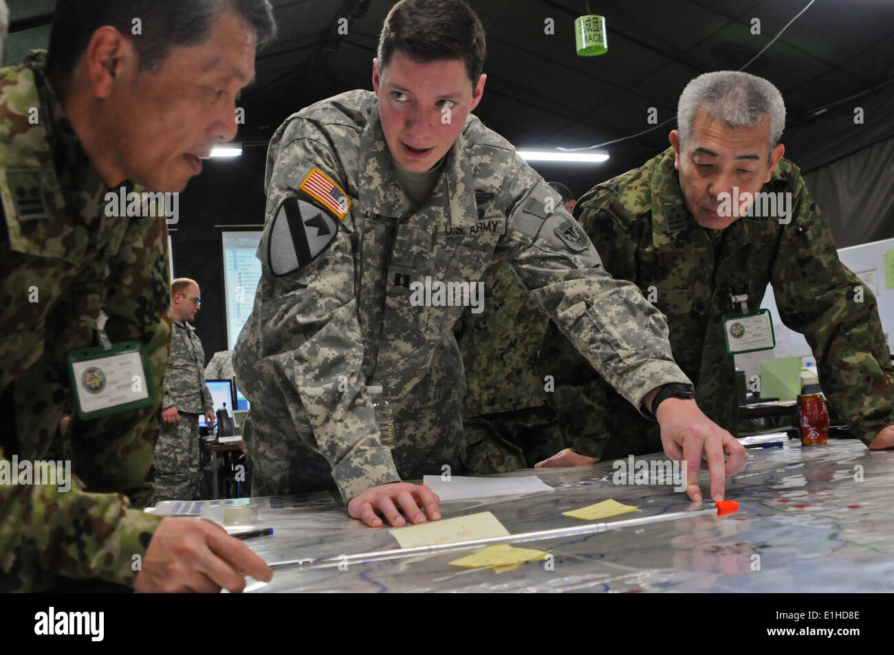 U.S. Army Capt. Jeremy Lyon, center, an infantry officer with the 332nd Rear Area Operations Center, discusses troop movements Stock Photo