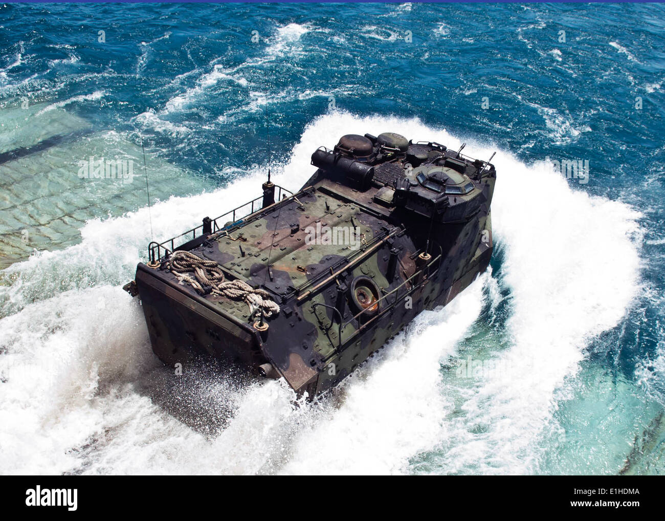 A U.S. Marine Corps amphibious assault vehicle plunges into the Gulf of Thailand as it exits the well deck of the amphibious do Stock Photo