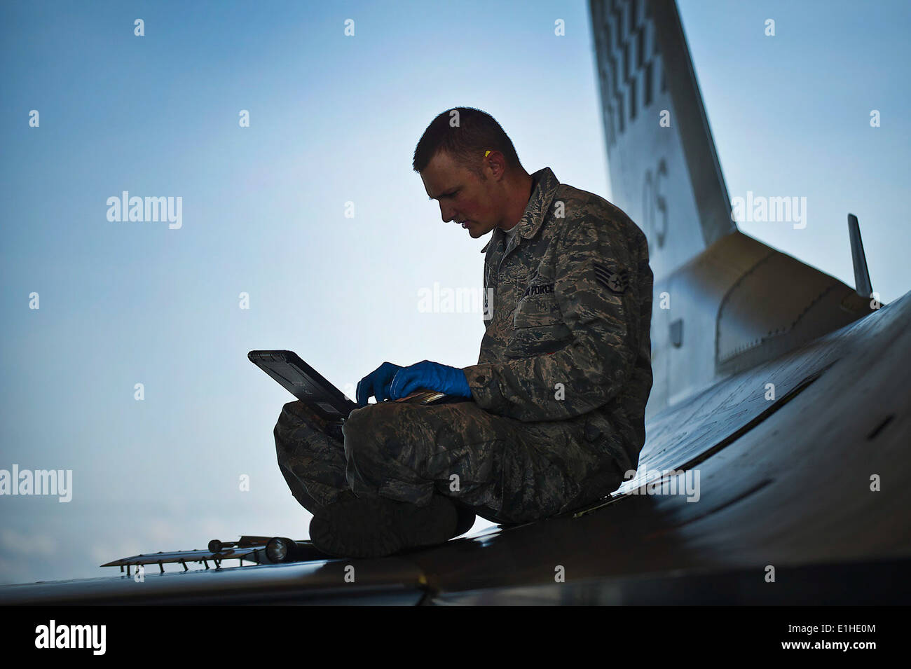 U.S. Air Force Staff Sgt. James Broome, a crew chief assigned to the 51st Aircraft Maintenance Squadron, references an electro Stock Photo