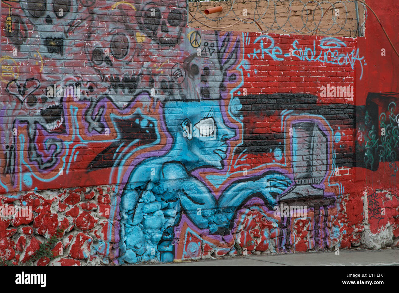 Urban art depicting a man at computer with skulls coming from head in the Spanish colonial city of Santiago de Queretaro Mexico Stock Photo