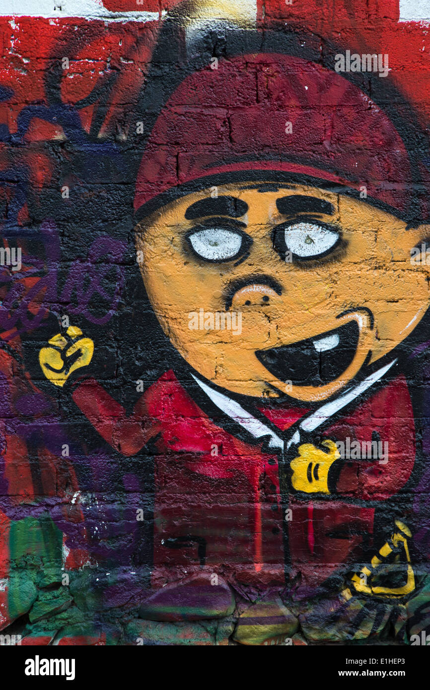 Urban art depicting a young toothless boy in the Spanish colonial city of Santiago de Queretaro, Mexico Stock Photo