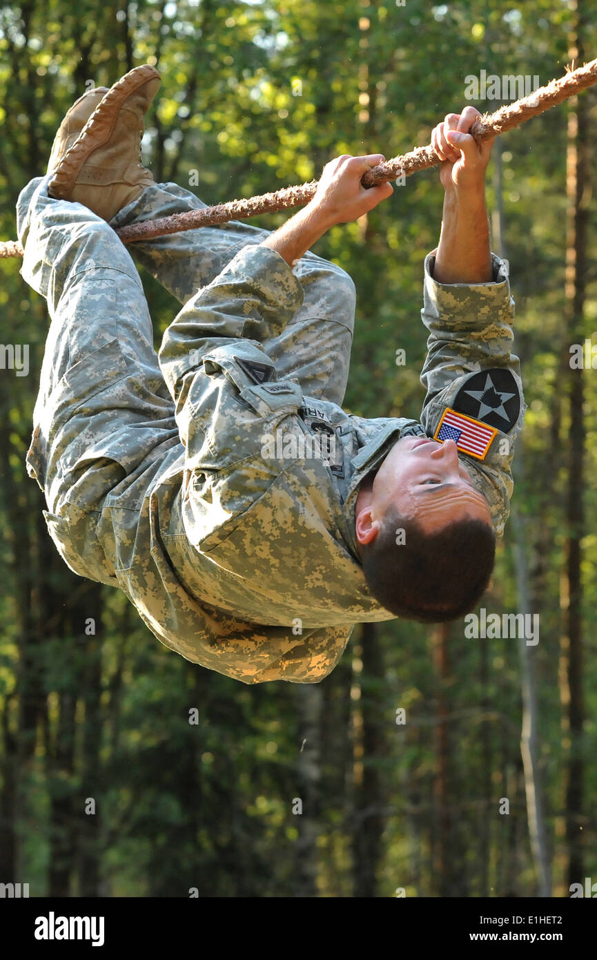 U.S. Army Capt. John Arthur, with the 1st Battalion, 4th Infantry Regiment, goes through an obstacle course during United State Stock Photo