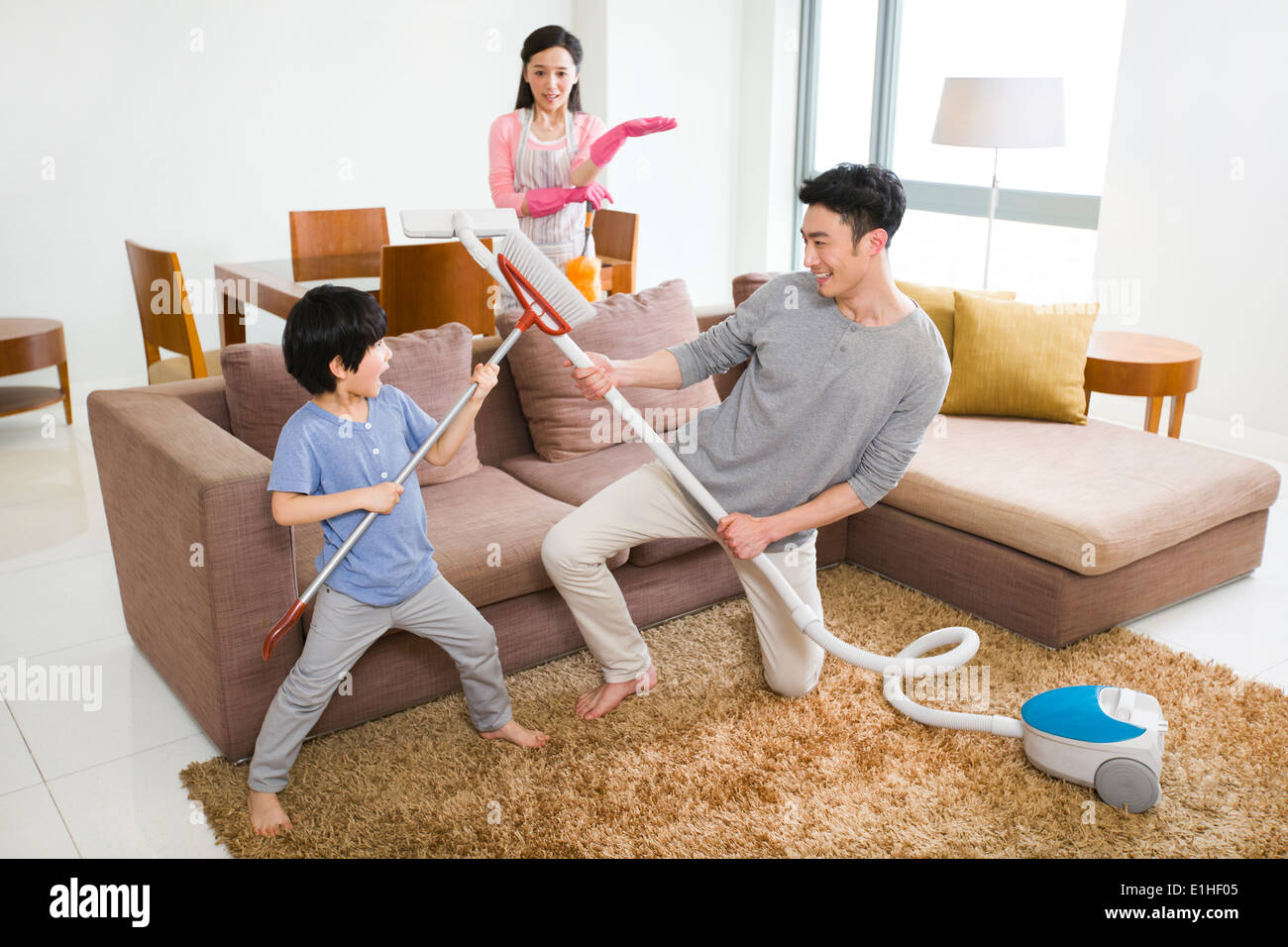 Happy family doing chores at home Stock Photo