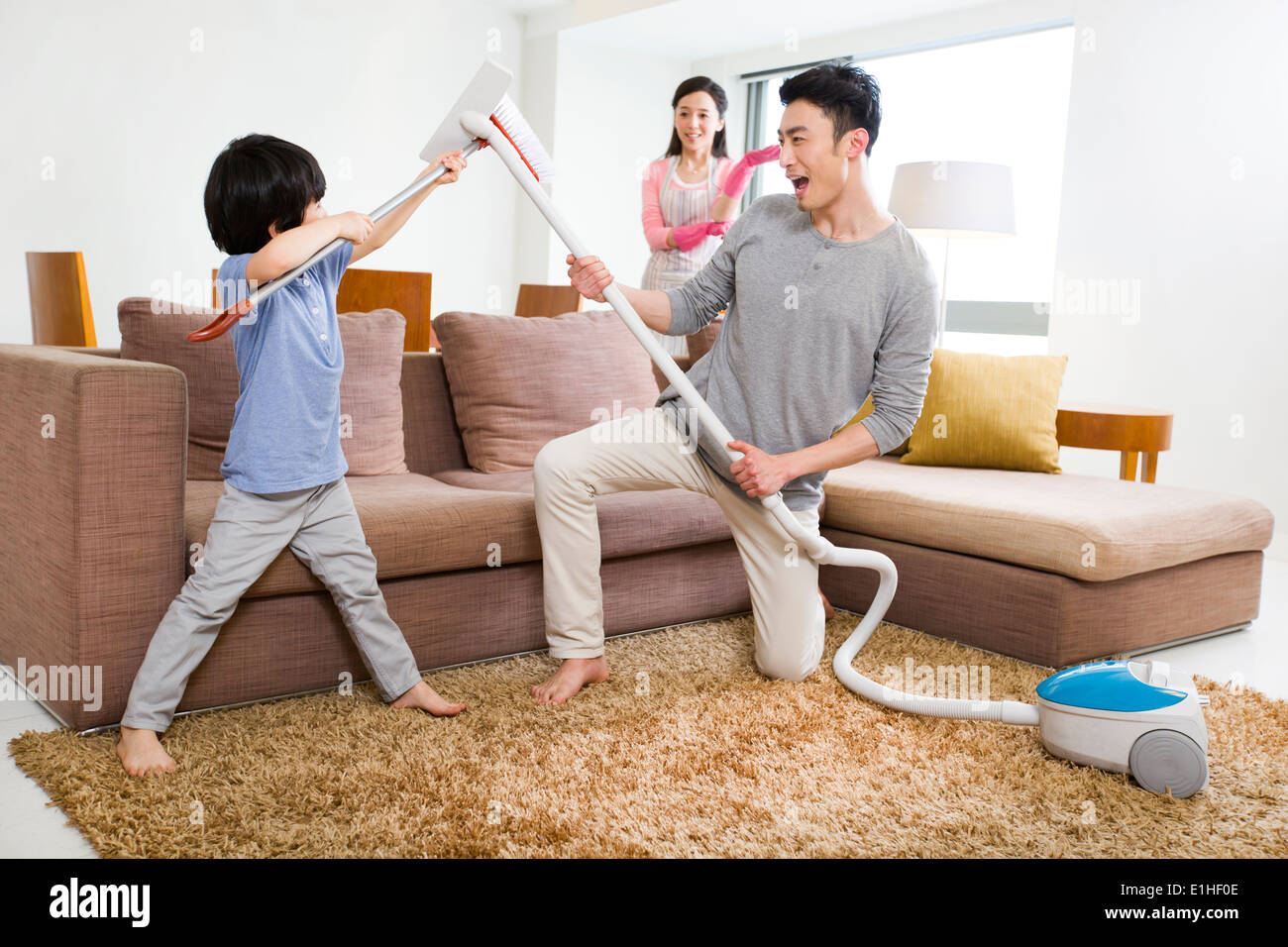 Happy family doing chores at home Stock Photo