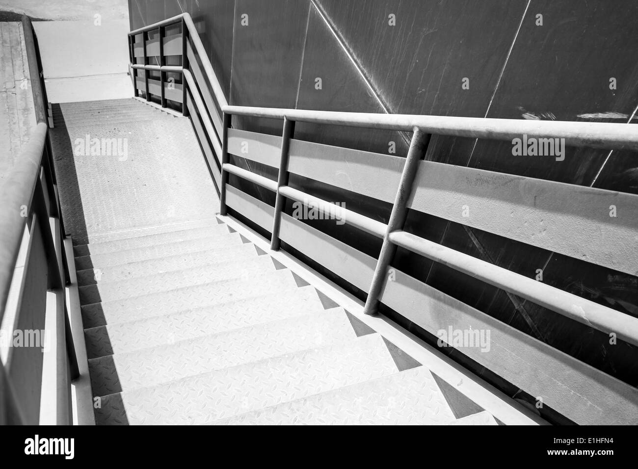 Industrial metal staircase perspective. Black and white photo Stock Photo