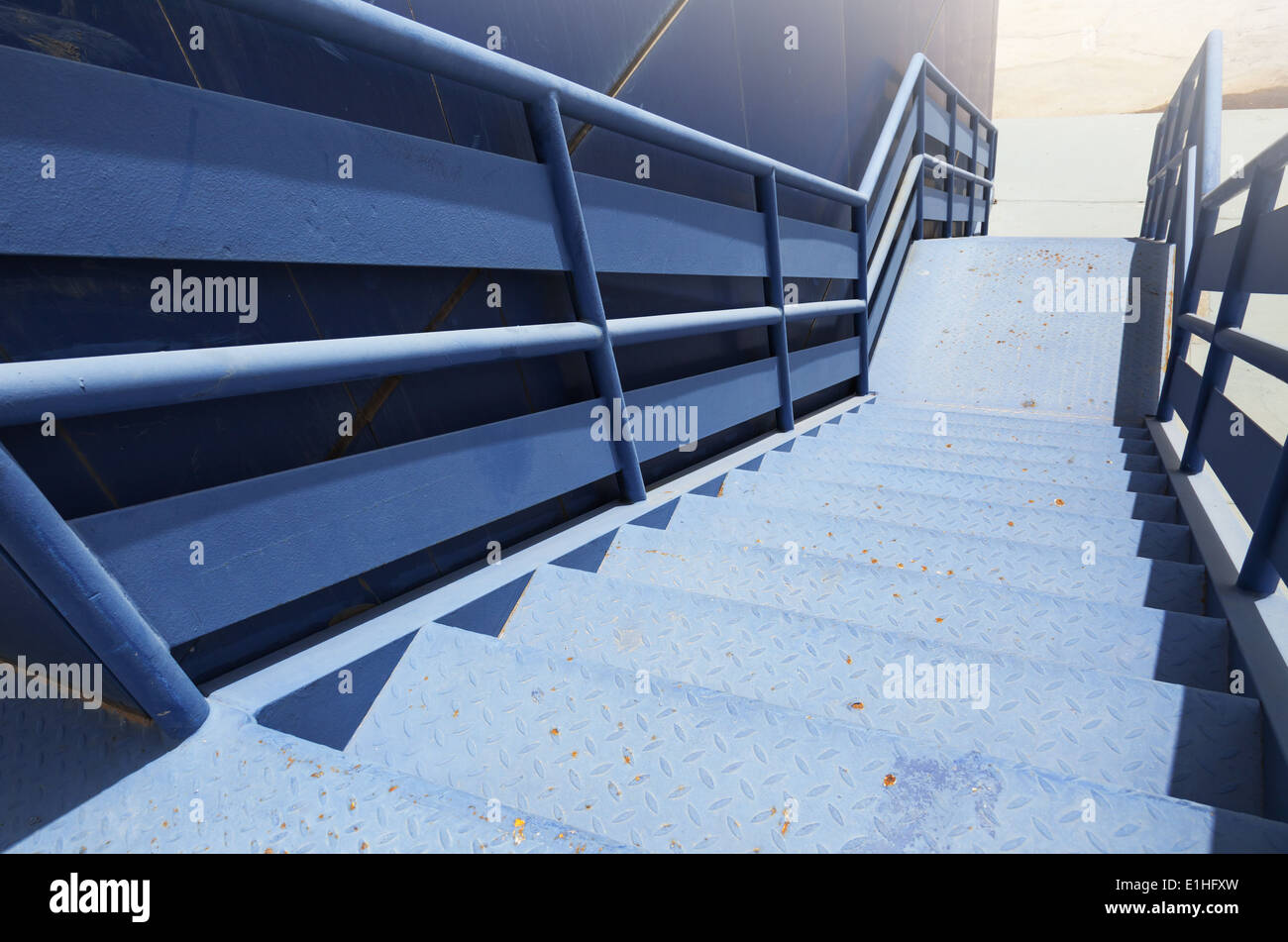 Perspective of blue industrial metal staircase going down Stock Photo