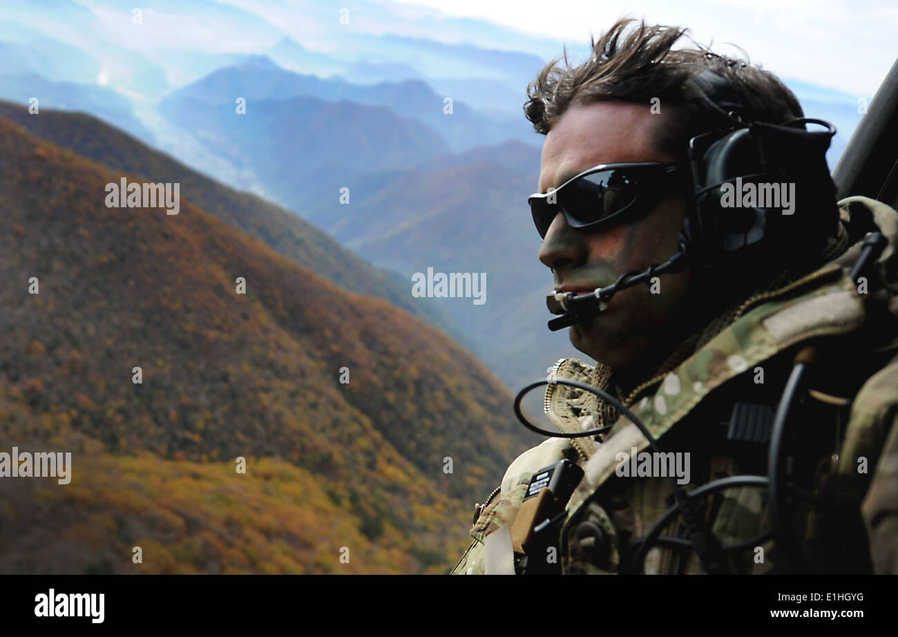 U.S. Air Force Tech. Sgt. Bobby Colliton, assigned to the 18th Operation Support Squadron, rides in an HH-60 Pave Hawk helicopt Stock Photo