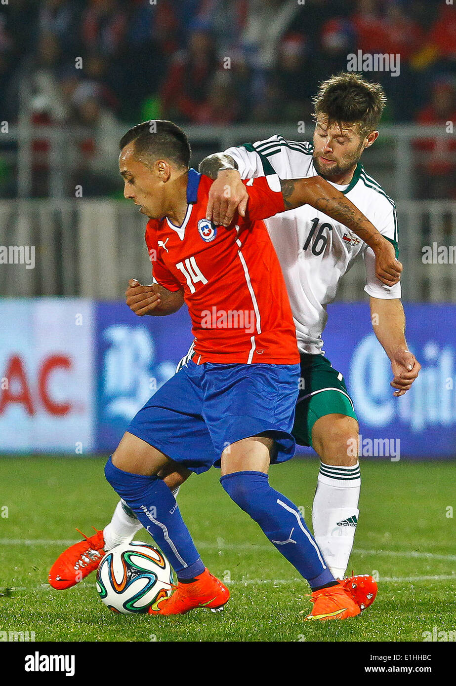 Valparaiso, Chile. 4th June, 2014. Chile's Fabian Orellana (L) vies for the ball with Oliver Norwood of Northern Ireland during a friendly match prior to the 2014 FIFA World Cup, held at Elias Figueroa Brander Stadium, in Valparaiso, Chile, on June 4, 2014. © Str/Xinhua/Alamy Live News Stock Photo