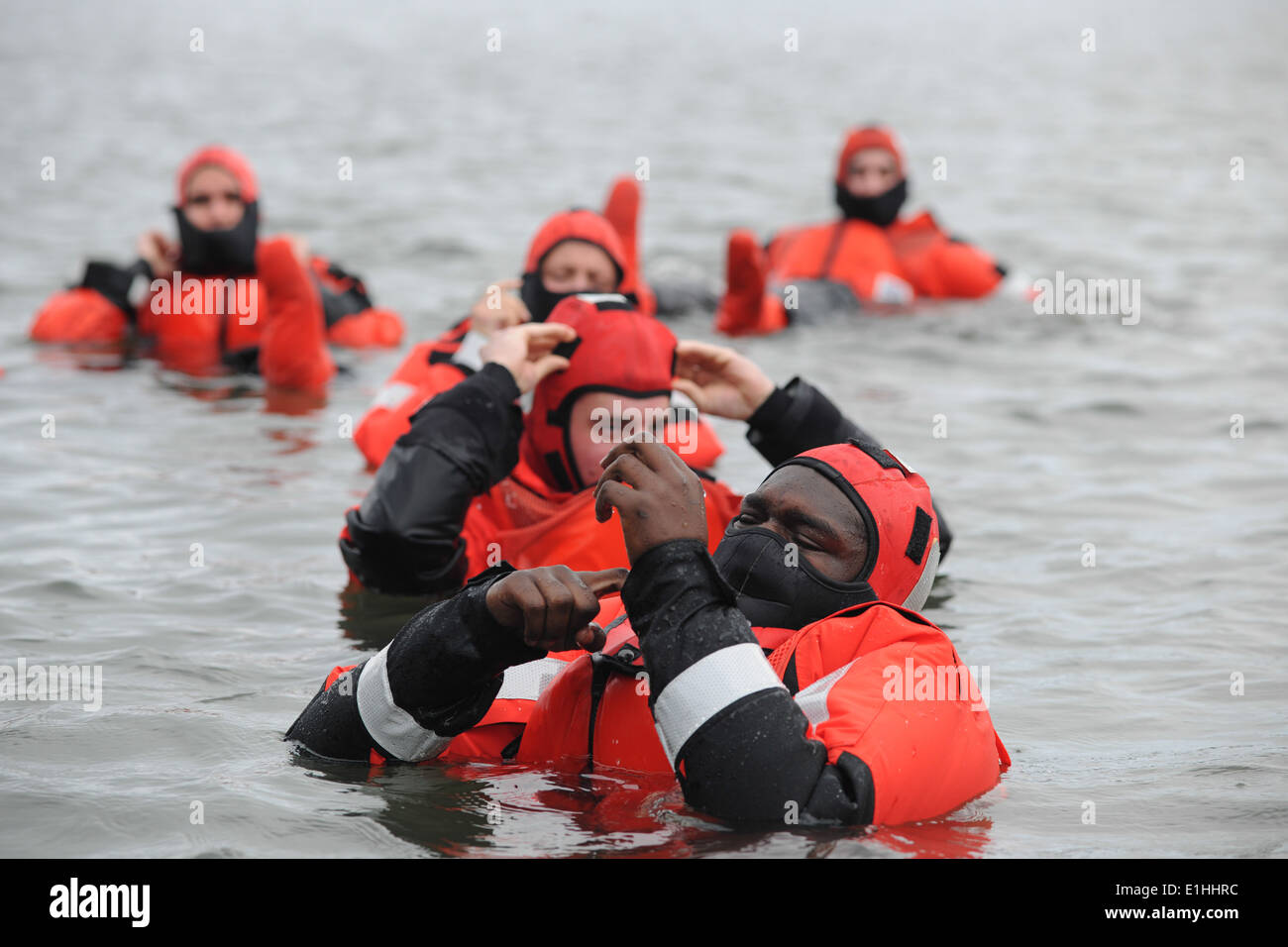 Seaman Kar Arrington lets out loose air through the sleeve of his cold weather dry suit during a survival swim training evoluti Stock Photo