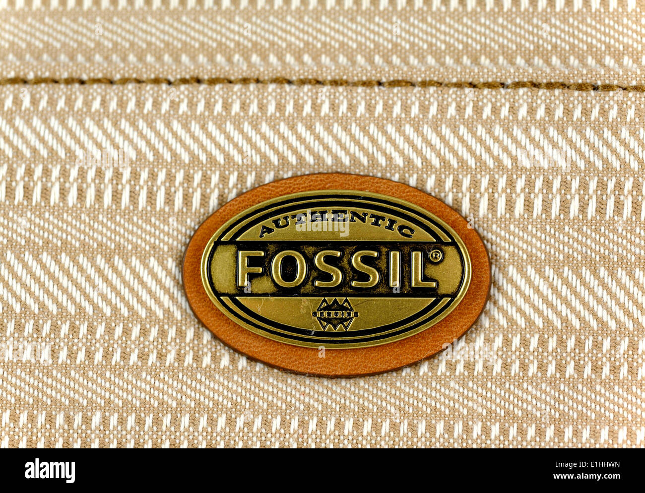 Fossil brand logo badge on a shoulder bag close up detail Stock Photo