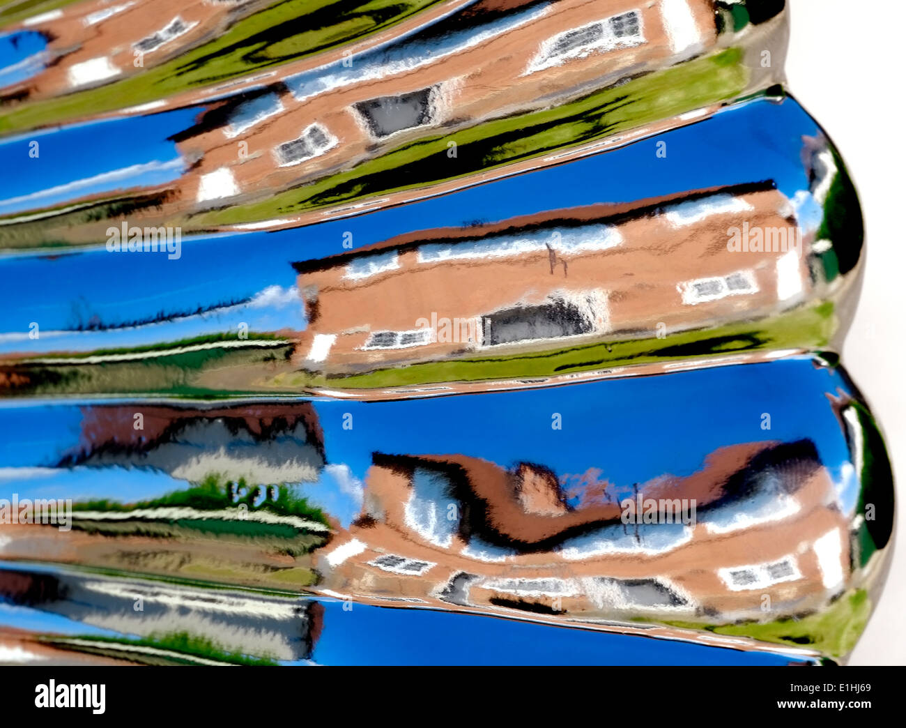 A warped image of a house and garden England uk. Reflection from a garden ornament Stock Photo