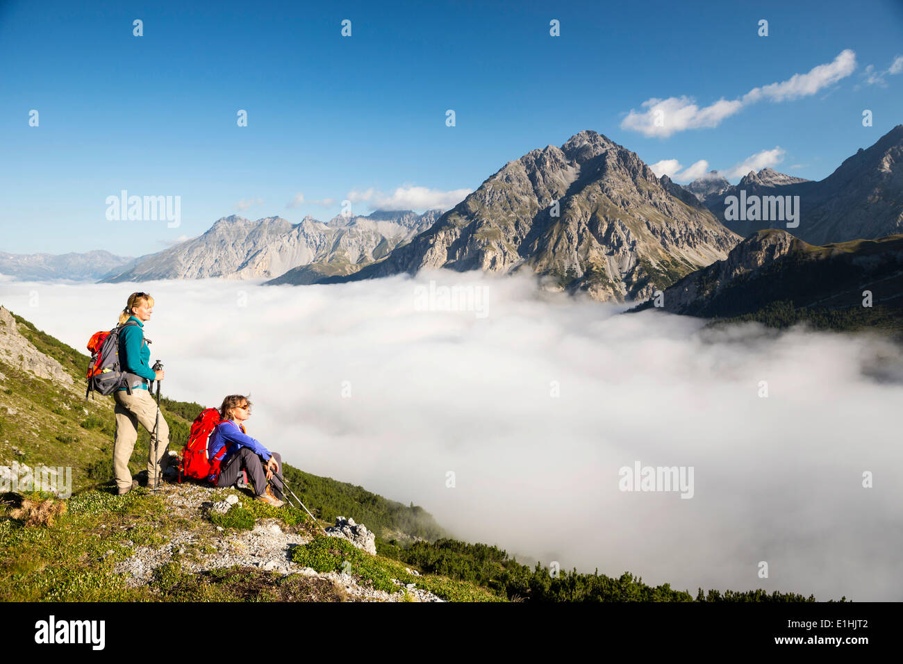 Two women hiking, low-hanging clouds in the Fuorn Pass, Swiss National Park, Graubünden, Switzerland Stock Photo