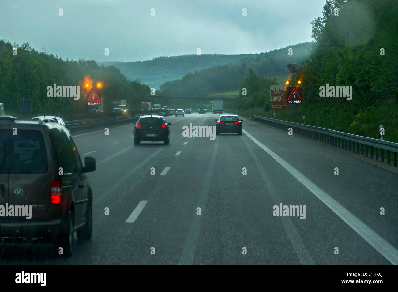 Traffic during heavy rain with poor visibility, warning sign indicating a risk of traffic jams, A9 motorway near Thalmässing Stock Photo