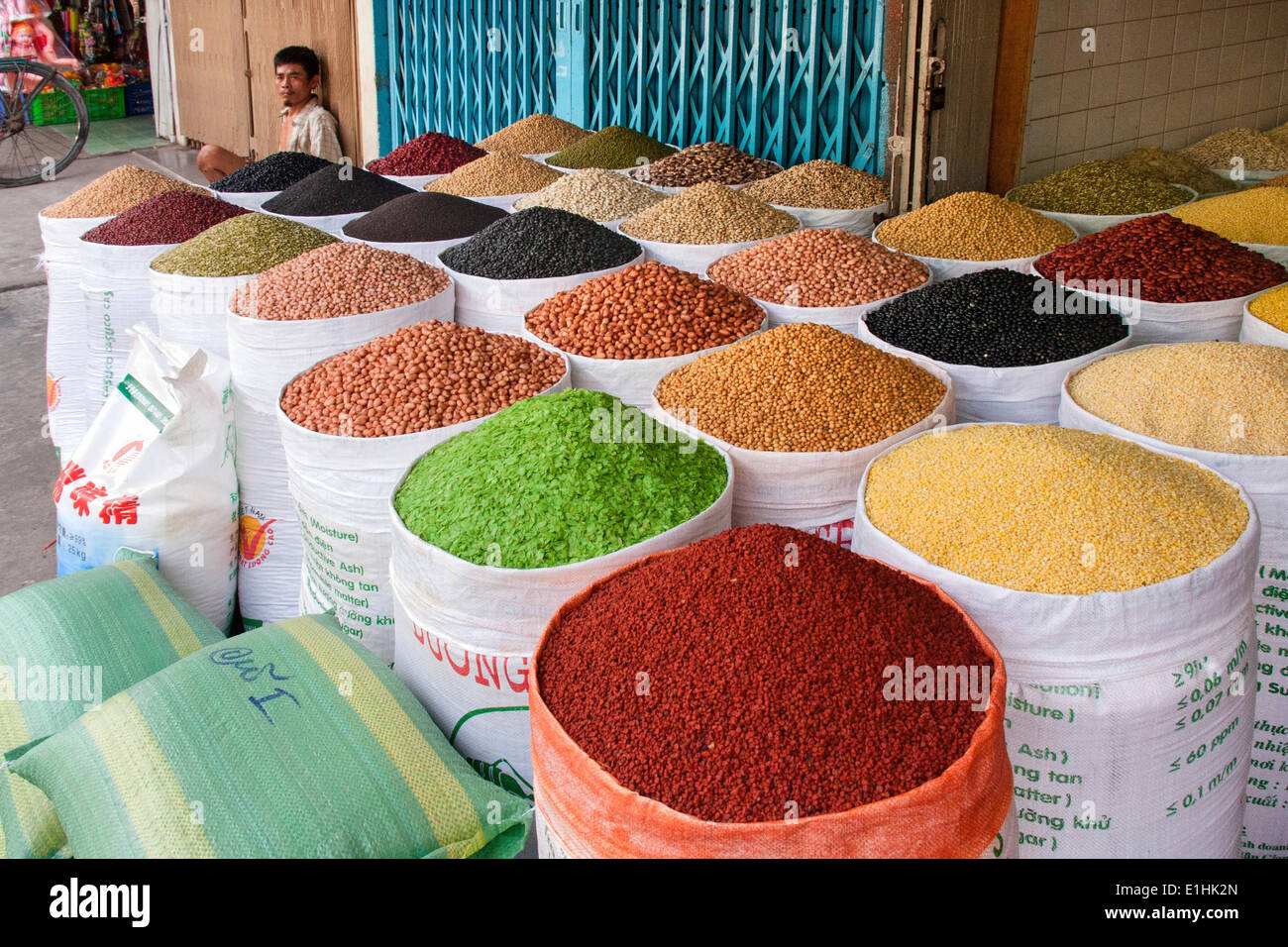 Market vendor offering various sorts of beans, spices and grains, Ho Chi Minh City, Vietnam Stock Photo