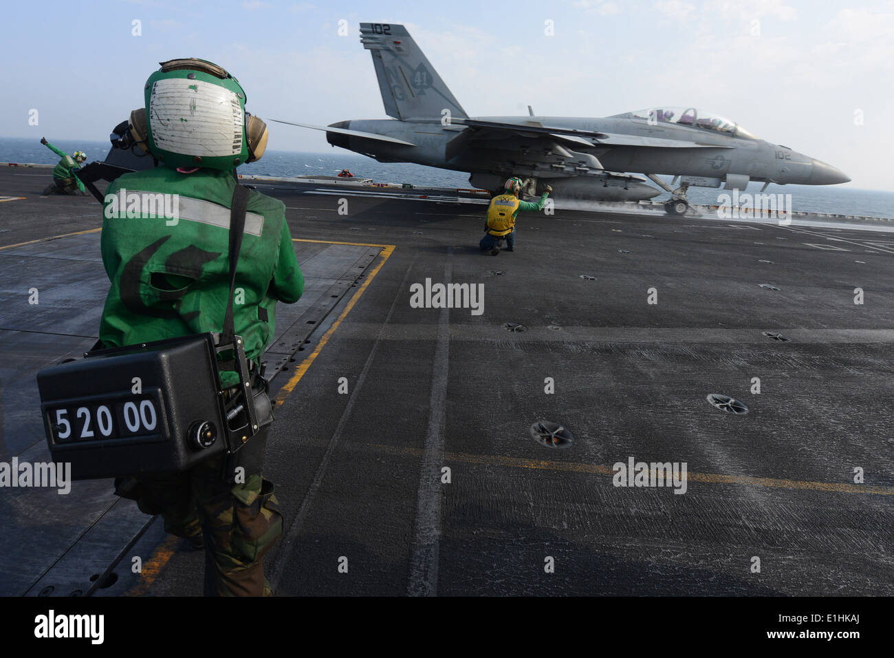 U.S. Navy Aviation Boatswain's Mate (Handling) 3rd Class Dannielle Byrum observes the launch of