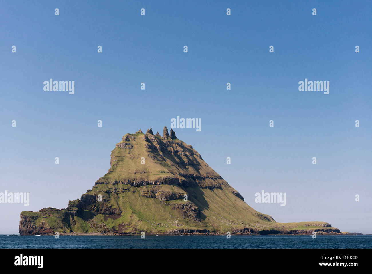 Islet of Tindhólmur or Tindholmur, rugged cliffs rising from the sea, Vágar, Faroe Islands, Denmark Stock Photo
