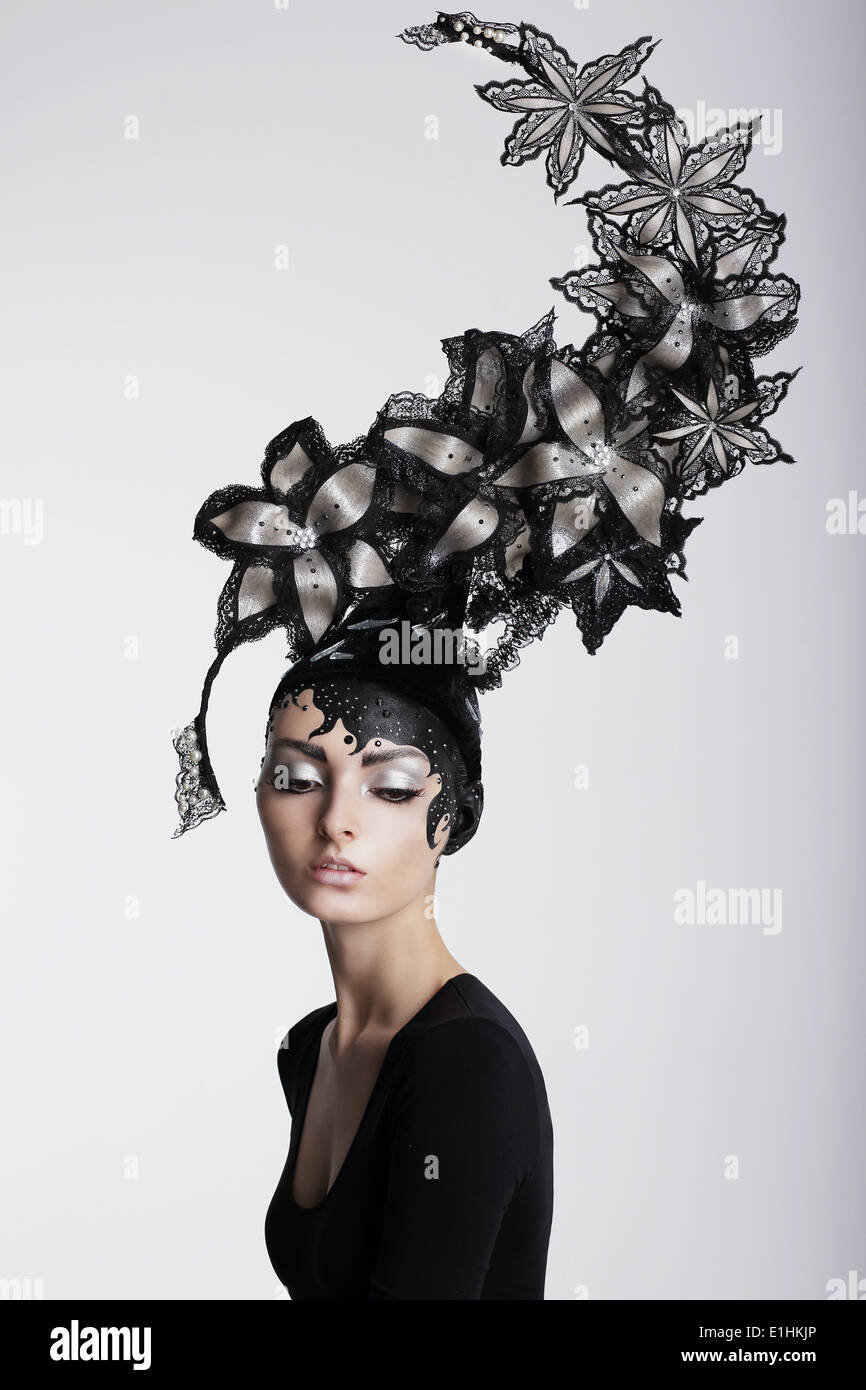 Fantasy. Surrealism. Amazing Woman in Trendy Headwear with Flowers Stock Photo