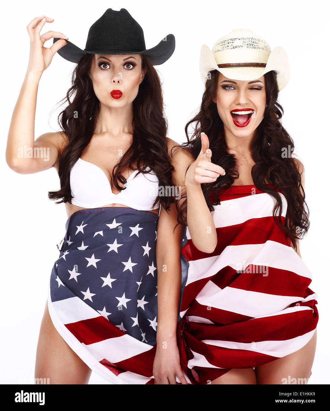 Two Ecstatic Showy Women Wrapped in USA Flag Stock Photo