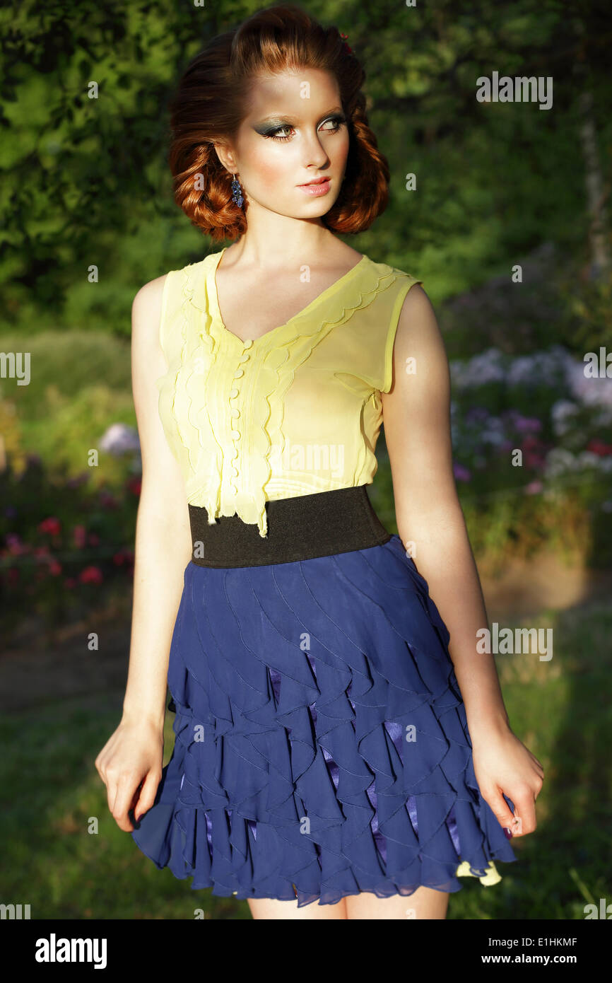 Simplicity. Young Red Hair Woman in Blue Skirt Looking Away Stock Photo