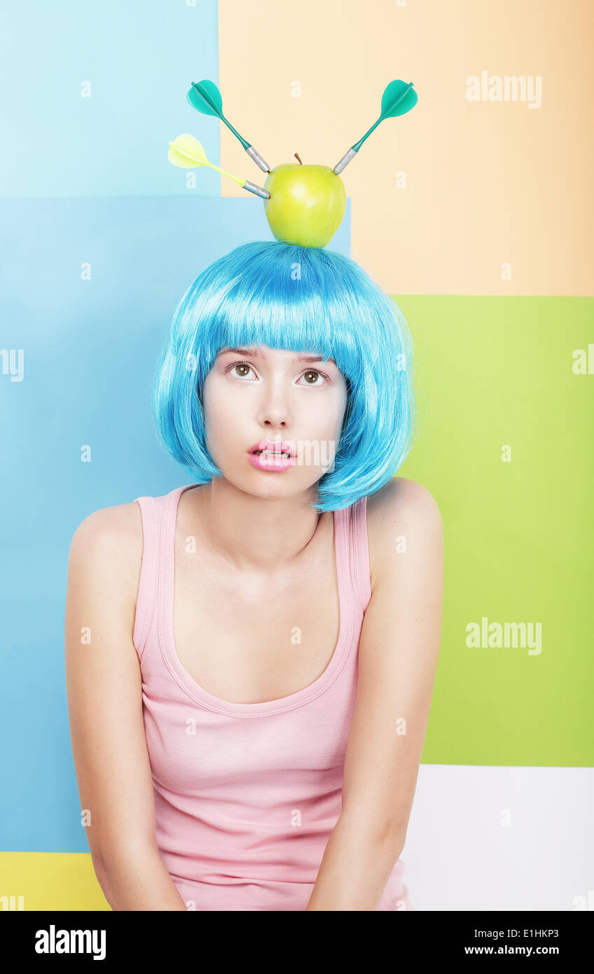 Stylized Woman with Apple on her Blue Haired Head. Series of Photos Stock Photo