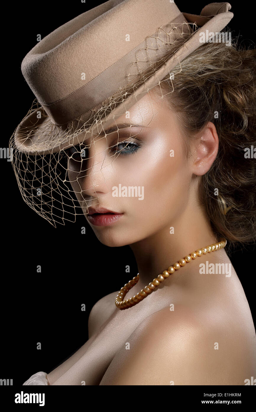 Charm. Retro Styled Romantic Woman in Vintage Brown Hat and Veil. Nostalgia Stock Photo