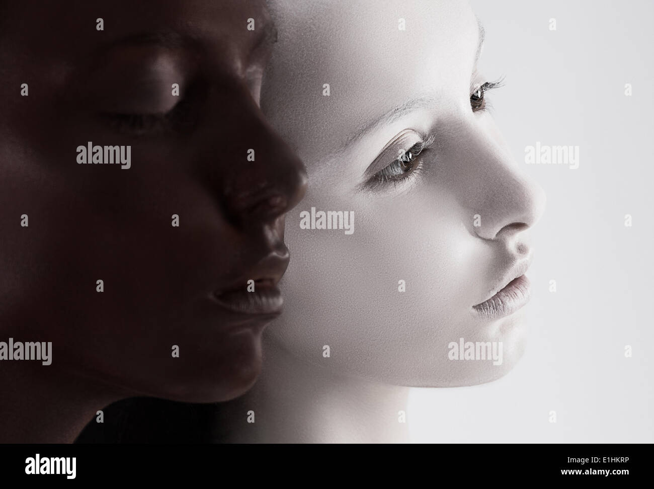 Cultural Diversity. Two Faces Colored Black & White. Yin Yang Style Stock Photo