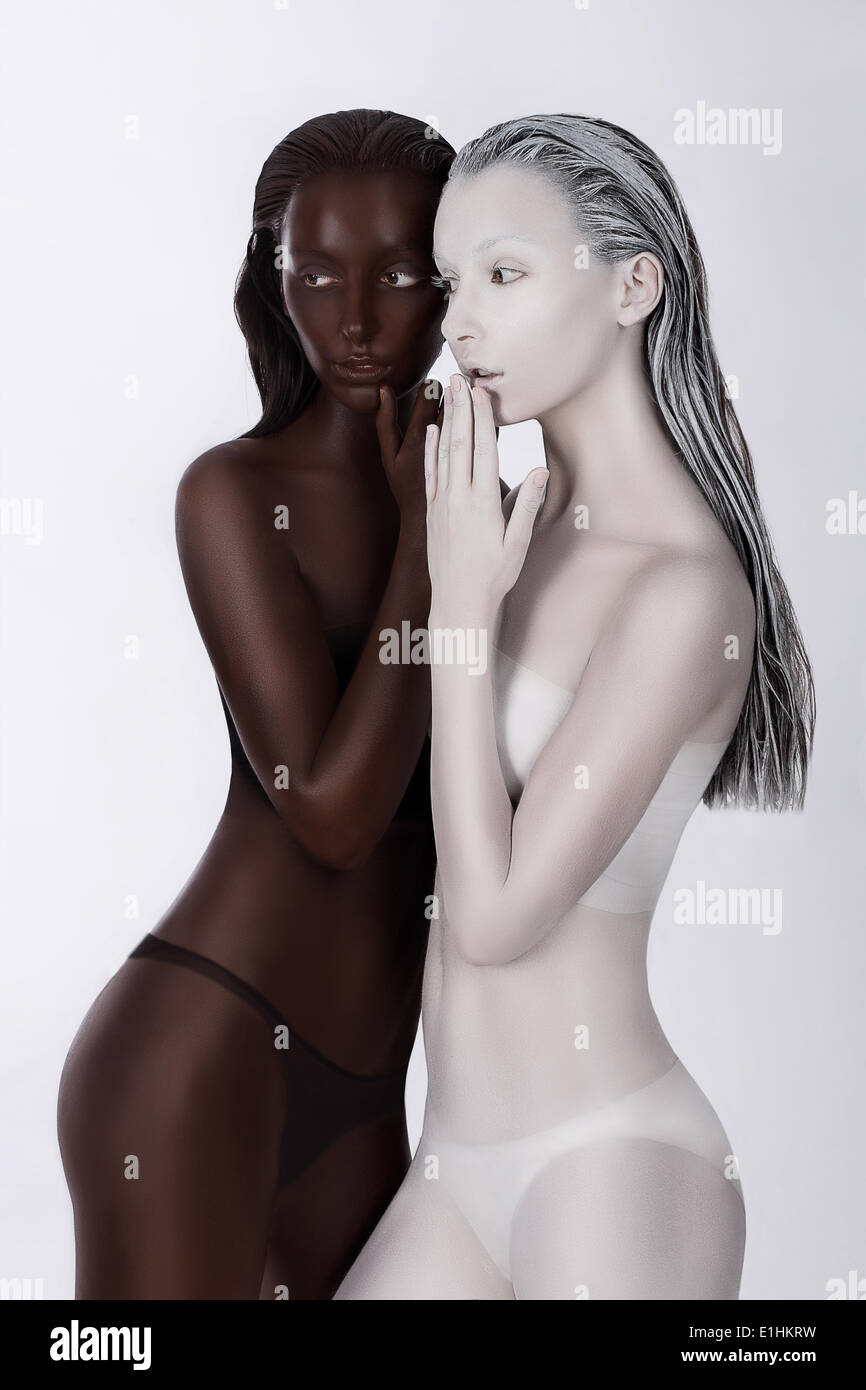 Ethnicity. Fantasy. Futuristic Women Painted White and Black. Art Bodypainting Stock Photo