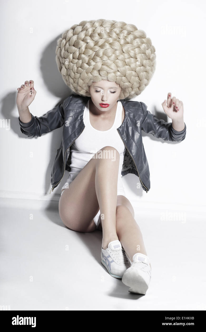 Extravagance. Eccentric Blonde Hair Model with Fantastic Updo Coiffure Stock Photo