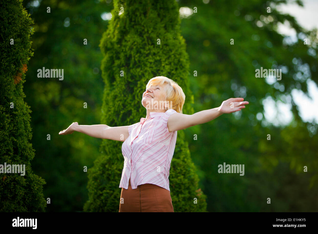 Lifestyle. Freedom. Excited Retired Old Woman with Outstretched Arms Stock Photo