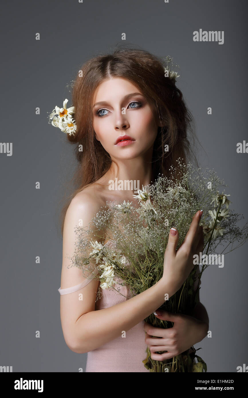 Sentimentality. Redhaired Affectionate Muse with Flowers in Dreams Stock Photo
