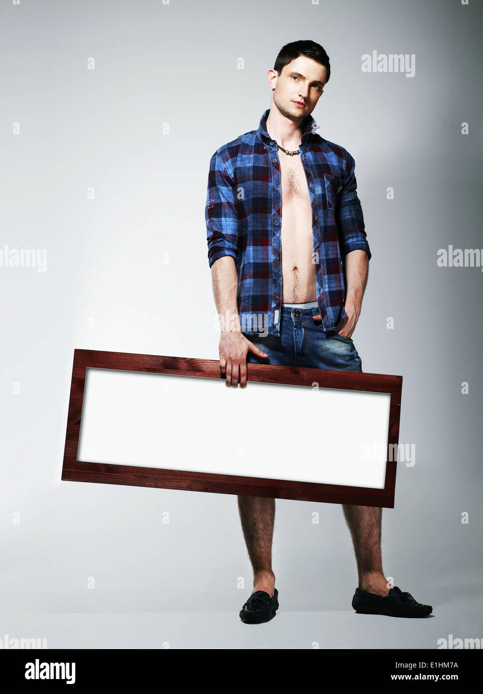 Young Man Showing Placard with White Blank Space Stock Photo