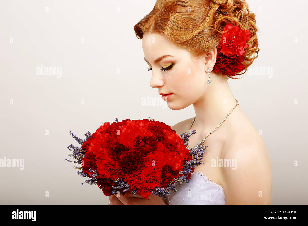 Mildness. Profile of Calm Woman with Red Bouquet of Flowers. Tranquility & Gentleness Stock Photo