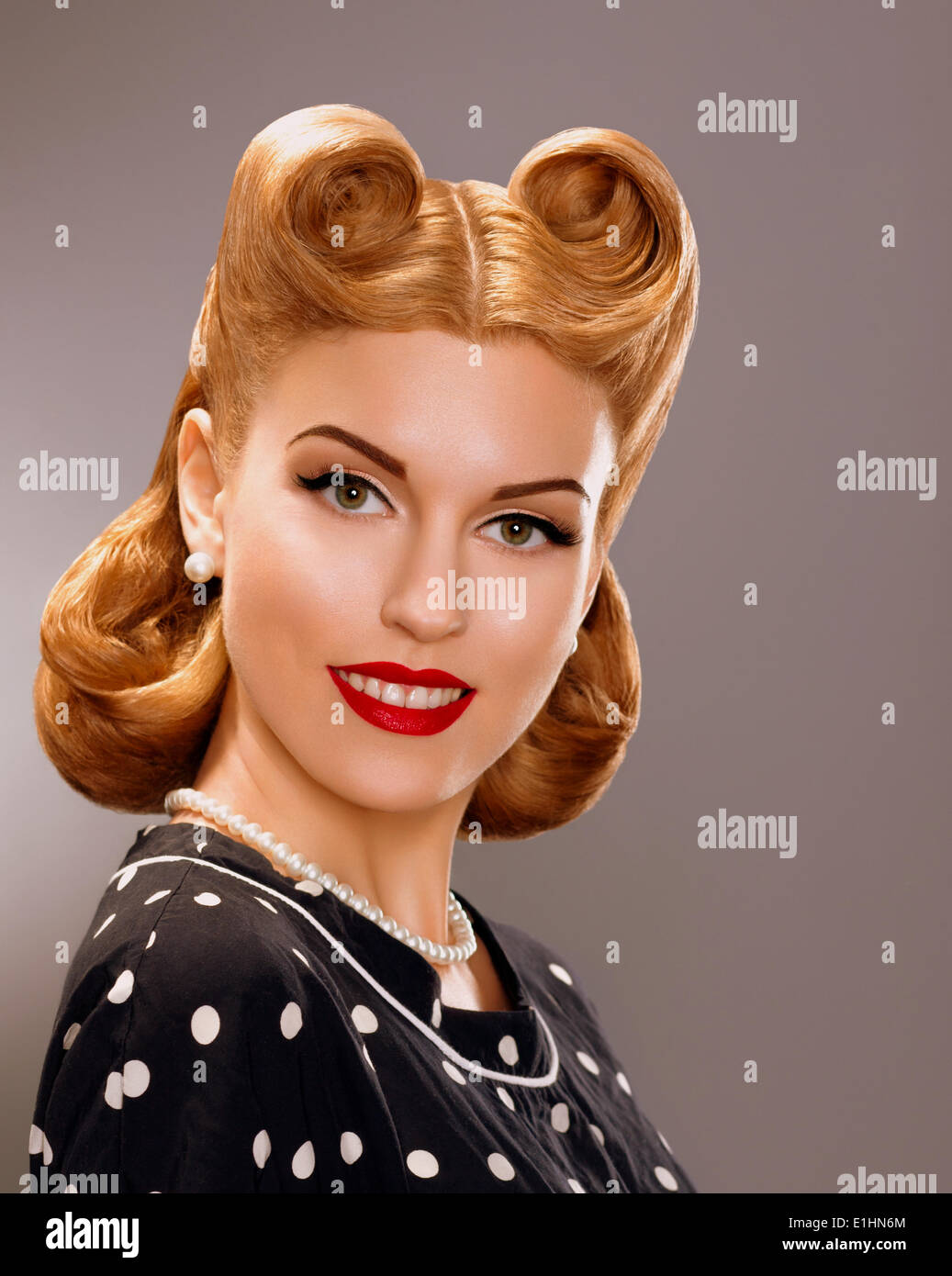 Nostalgia. Styled Smiling Woman with Retro Golden Hair Style. Nobility Stock Photo