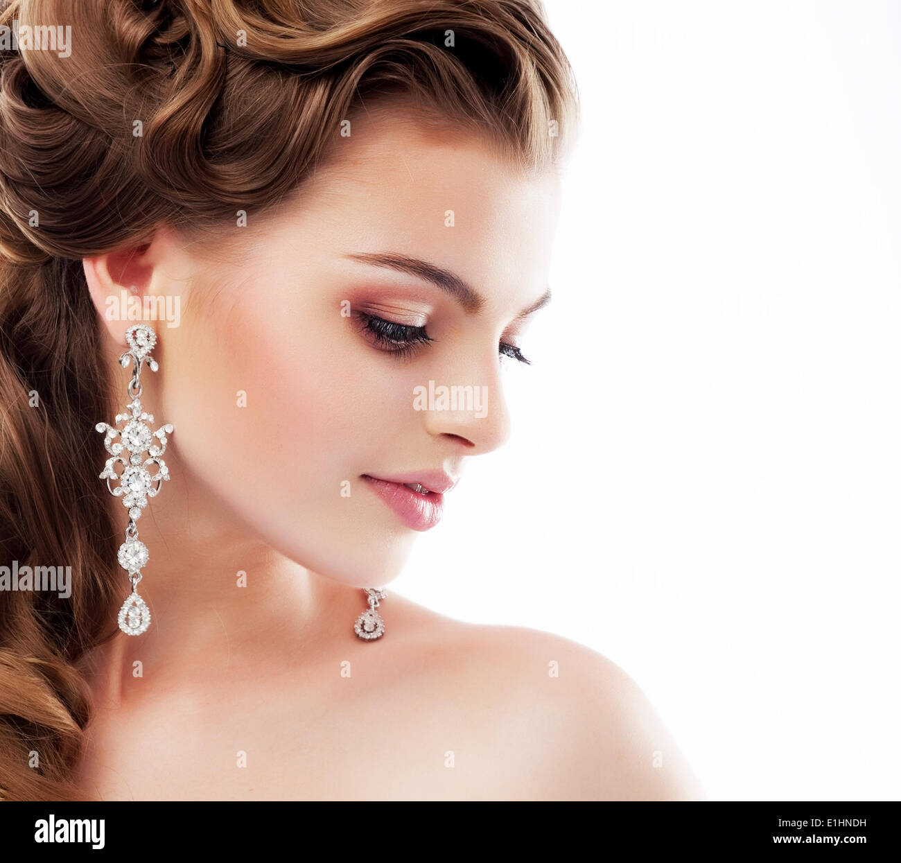 Pure Beauty. Aristocratic Profile of smiling Lady with Glossy Diamond Earrings. Femininity & Sophistication Stock Photo