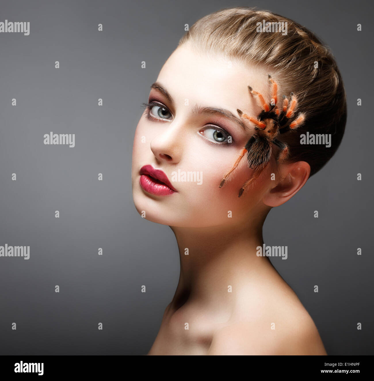 Fantasy. Spider sitting on Pretty Woman Face. Creativity Stock Photo
